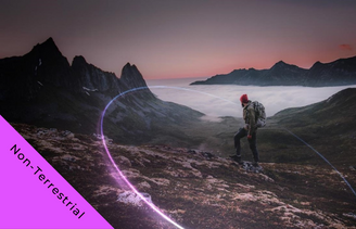 Man standing on mountain with ring of purple light around him